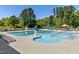 Large community pool with seating, umbrellas, and a slide for endless summer fun at 713 Putney Hill Rd, Zebulon, NC 27597