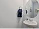 Elegant powder room featuring a pedestal sink, round mirror, and minimalist decor at 713 Putney Hill Rd, Zebulon, NC 27597