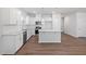 Bright kitchen features white cabinetry, stainless steel appliances, granite countertops, and island at 728 Ben Ledi Ct, Raleigh, NC 27603