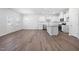 Open-concept kitchen with white cabinetry, stainless steel appliances, granite countertops, and island at 728 Ben Ledi Ct, Raleigh, NC 27603