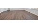 Spacious living room with wood-look flooring, neutral paint, and plenty of natural light at 728 Ben Ledi Ct, Raleigh, NC 27603