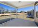 View from the screened porch looking out over a bright lawn with homes in the distance at 728 Ben Ledi Ct, Raleigh, NC 27603