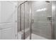 A tiled shower with a glass door and a built-in bench offers a luxurious and relaxing experience at 728 Ben Ledi Ct, Raleigh, NC 27603