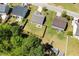 Aerial view of property showcasing a large, fenced backyard with patio. Surrounded by mature trees and neighborhood homes at 729 Golden Horseshoe Ln, Sanford, NC 27330