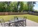 Spacious backyard featuring a patio area, lush green lawn, and a wooden privacy fence at 729 Golden Horseshoe Ln, Sanford, NC 27330