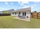 Well-maintained backyard with a patio area, manicured lawn, and privacy fence at 729 Golden Horseshoe Ln, Sanford, NC 27330