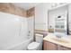 Bathroom featuring tiled shower/tub, vanity with sink, and large mirror at 729 Golden Horseshoe Ln, Sanford, NC 27330