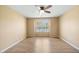 Spacious bedroom featuring wood floors, ceiling fan, and window letting in natural light at 729 Golden Horseshoe Ln, Sanford, NC 27330