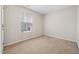 Bedroom featuring neutral paint, carpet and a window to let in natural light at 729 Golden Horseshoe Ln, Sanford, NC 27330