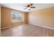 Bedroom with wood-look floors, light walls, and a window providing natural light at 729 Golden Horseshoe Ln, Sanford, NC 27330