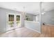 Bright dining area with wood-look floors, a chandelier, and French doors leading to the backyard at 729 Golden Horseshoe Ln, Sanford, NC 27330