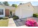 Front view of a charming home with a brick facade and a well-kept lawn leading to an attached two-car garage at 729 Golden Horseshoe Ln, Sanford, NC 27330