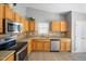 Well-maintained kitchen featuring oak cabinets, stainless steel appliances, and neutral countertops at 729 Golden Horseshoe Ln, Sanford, NC 27330