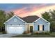 Charming single-story home featuring a two-car garage, well-manicured lawn, and craftsman-style details under a colorful sky at 740 Ben Ledi Ct, Raleigh, NC 27603