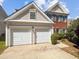 Charming home featuring a two-car garage and a blend of brick and siding exterior at 7425 Silver View Ln, Raleigh, NC 27613