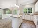 The kitchen features stainless steel appliances, white cabinetry and lots of windows at 7425 Silver View Ln, Raleigh, NC 27613