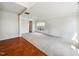Open-concept living room with hardwood floors, plush carpet, and natural light from the large windows at 7425 Silver View Ln, Raleigh, NC 27613
