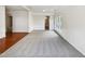 Expansive living area featuring hardwood floors, plush carpet, natural light, and dining space at 7425 Silver View Ln, Raleigh, NC 27613