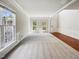 Bright living room with hardwood floors, plush carpet, natural light, and a view of the front yard at 7425 Silver View Ln, Raleigh, NC 27613