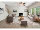 Staged living room featuring a fireplace, ceiling fan, and neutral colors at 7425 Silver View Ln, Raleigh, NC 27613