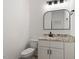 Modern bathroom with a decorative mirror, granite countertop, and black hardware at 811 Fargo St, Durham, NC 27707