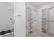 Modern bathroom featuring a glass-enclosed shower with gray tile and a walk-in closet with custom shelving at 811 Fargo St, Durham, NC 27707