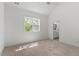 Bright bedroom with large window and natural light features a ceiling fan and neutral decor at 811 Fargo St, Durham, NC 27707