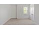 Minimal bedroom with neutral carpet, crisp white walls, and large windows bringing in natural light at 811 Fargo St, Durham, NC 27707