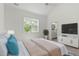 Bedroom features a ceiling fan, window with backyard views and an ensuite bathroom at 811 Fargo St, Durham, NC 27707