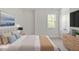 Bedroom with plush upholstered headboard, large window and adjacent dresser at 811 Fargo St, Durham, NC 27707