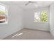 Minimal bedroom featuring neutral carpet, crisp white walls, and several large windows bringing in natural light at 811 Fargo St, Durham, NC 27707