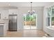 Open dining area with chandelier, sliding door access to outdoor space, adjacent to the kitchen at 811 Fargo St, Durham, NC 27707