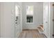 Bright entryway with a window, wood-look flooring, and convenient access to the stairs at 811 Fargo St, Durham, NC 27707