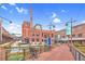 Exterior view of a charming outdoor area with seating, a brick walkway, and a scenic waterfront at 811 Fargo St, Durham, NC 27707