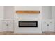Modern fireplace with a wooden mantel and built-in white cabinetry at 811 Fargo St, Durham, NC 27707