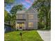 Charming two-story home with board and batten siding, covered porch, and well-manicured lawn at 811 Fargo St, Durham, NC 27707