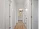 Hallway leads to bathroom with vanity, mirror and granite countertop at 811 Fargo St, Durham, NC 27707