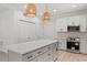Bright kitchen features pendant lighting, stainless steel appliances, and a center island with a marble countertop at 811 Fargo St, Durham, NC 27707