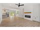 Open-concept living room with modern fireplace and hardwood floors leading to dining and kitchen at 811 Fargo St, Durham, NC 27707