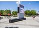 Outdoor plaza featuring a modern display board, picnic tables, and manicured landscaping at 811 Fargo St, Durham, NC 27707