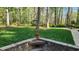 Well-manicured backyard featuring lush lawn, planting beds and a sitting area at 85 Rivers Edge Ct, Timberlake, NC 27583