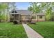 Landscaped backyard featuring a patio and path to the screened-in porch at 85 Rivers Edge Ct, Timberlake, NC 27583