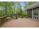 Wooden deck overlooking the brick patio and wooded back yard at 85 Rivers Edge Ct, Timberlake, NC 27583