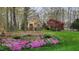 Charming two-story home with a stone accents, shutters and beautiful landscaped garden at 85 Rivers Edge Ct, Timberlake, NC 27583