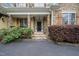 Charming front porch with stone pillars and lush landscaping at 85 Rivers Edge Ct, Timberlake, NC 27583