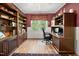 Spacious home office features custom built-ins, wooden floors, and a bright window for a productive workspace at 85 Rivers Edge Ct, Timberlake, NC 27583