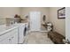 Functional laundry room with washer, dryer, sink, and storage shelves at 85 Rivers Edge Ct, Timberlake, NC 27583