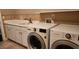 Laundry area with washer, dryer, and sink with cabinet storage at 85 Rivers Edge Ct, Timberlake, NC 27583
