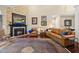Cozy living room with a stone fireplace, leather seating, and a patterned area rug at 85 Rivers Edge Ct, Timberlake, NC 27583