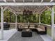 Back deck featuring a covered lounge area with string lights, overhead lights, and a grill for outdoor cooking at 8805 Stage Ford Rd, Raleigh, NC 27615